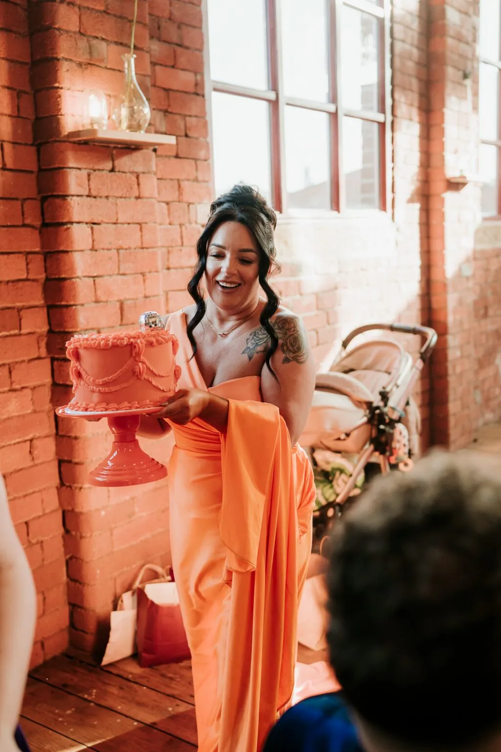 Bridesmaid carrying the orange Chocolate Orange wedding cake