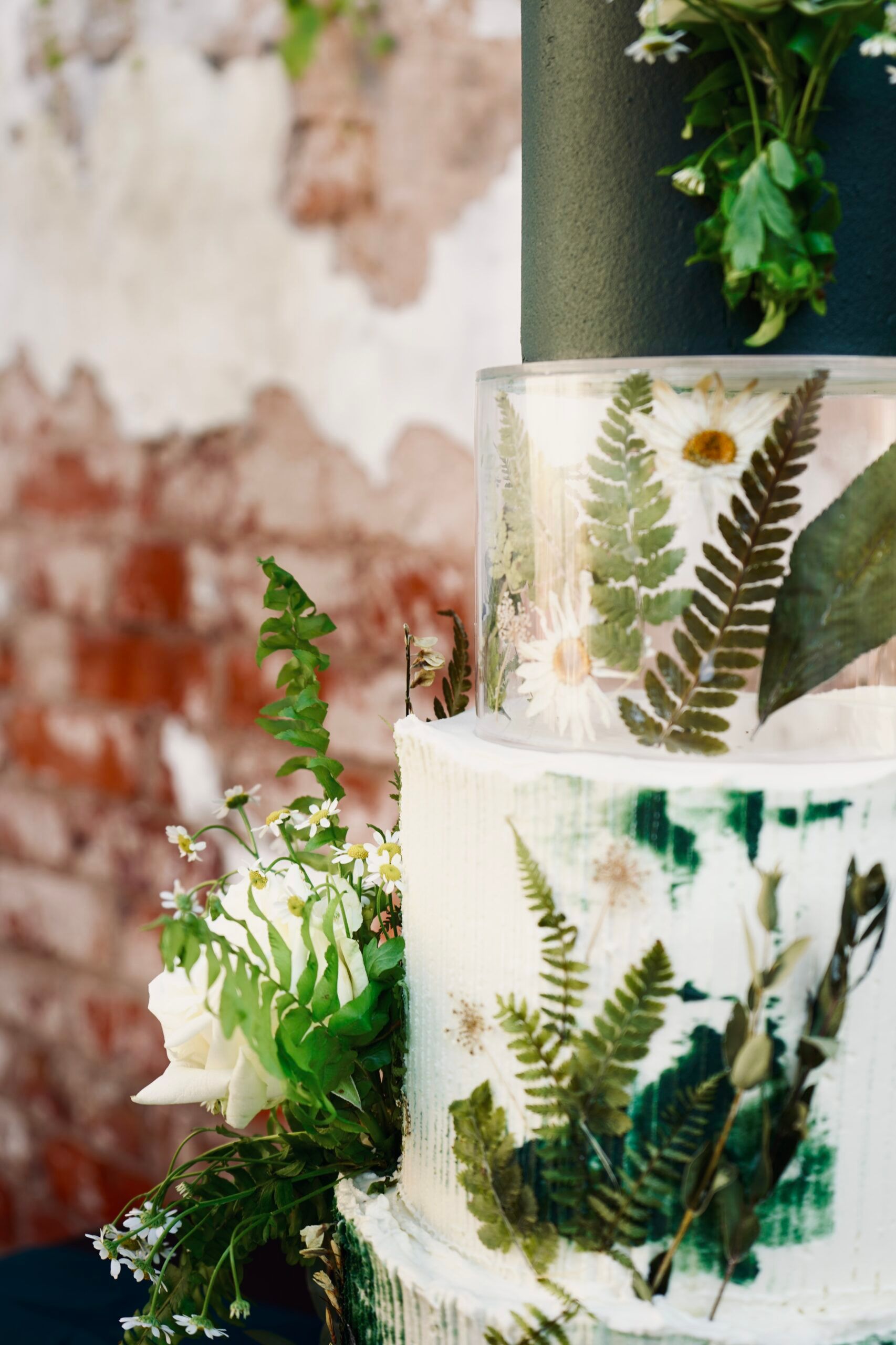 Moody editorial wedding cake styled with dark florals