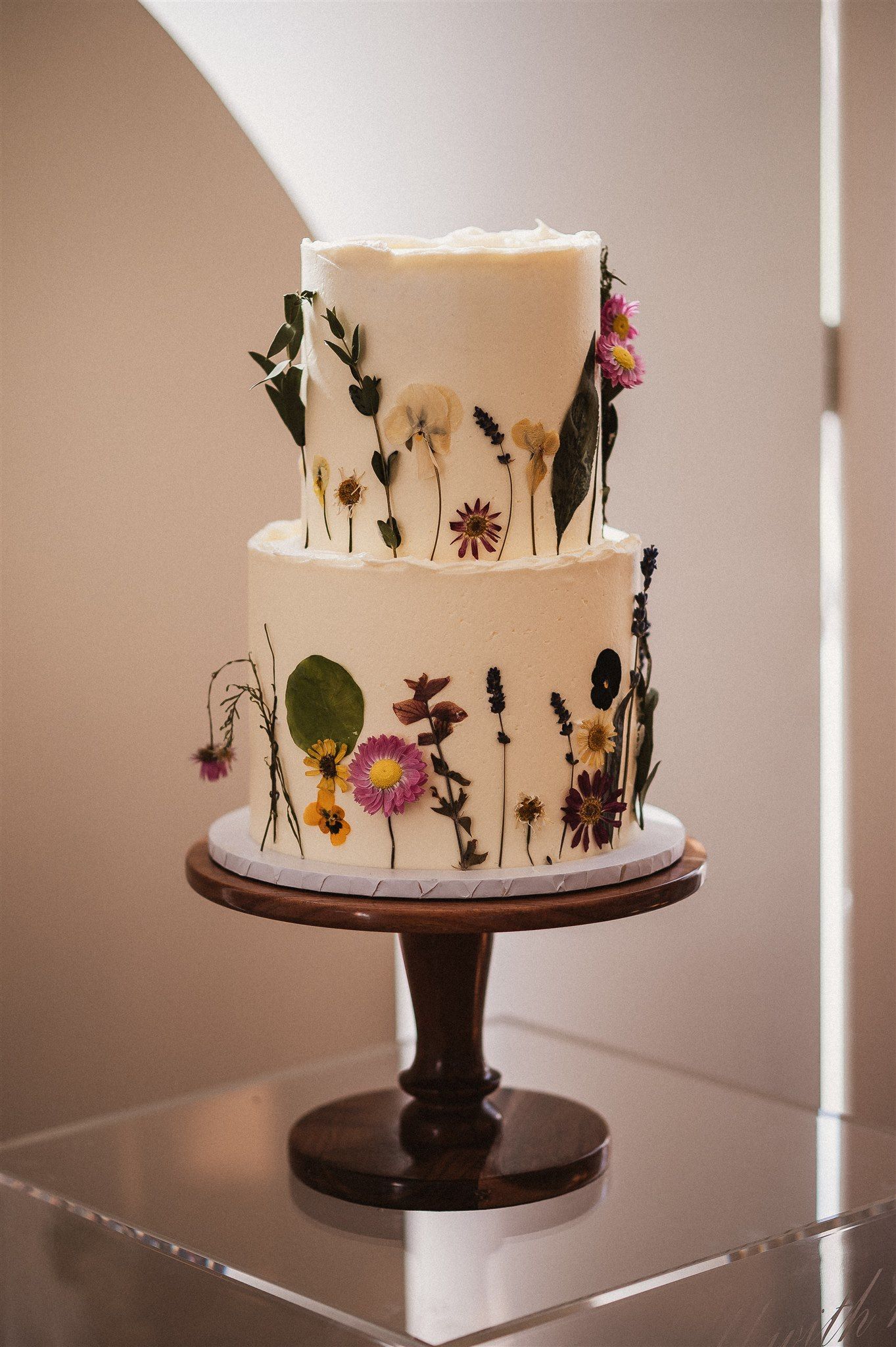 Tall romantic wedding cake with cascading florals