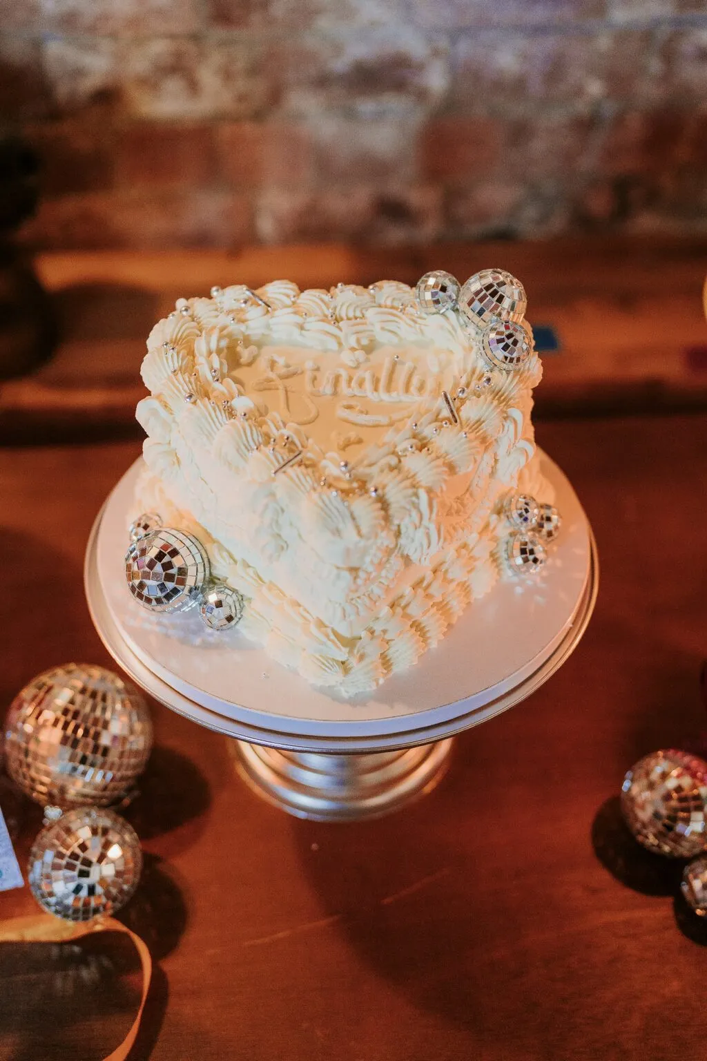 Close-up of the white Cherry Bakewell Lambeth wedding cake with disco ball details